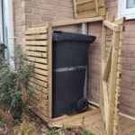 Treated timber bin-store with lid and door open