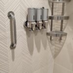 fittings attached to tile wall in shower room