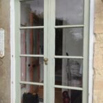 French doors in need of repair and painting