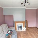 Room painted pink with grey feature wall